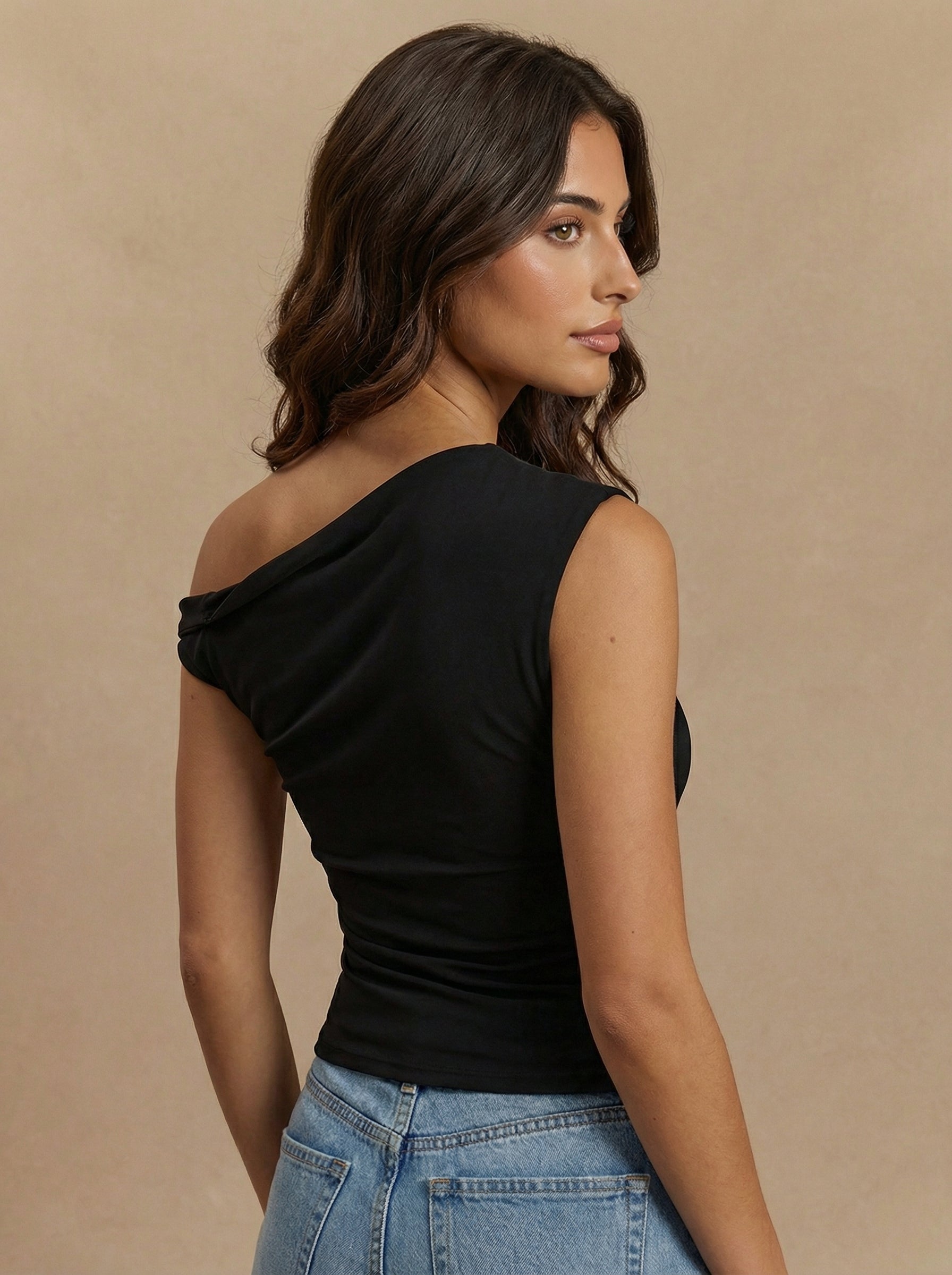 side_view_of_woman_in_black_one-shoulder_top.jpg